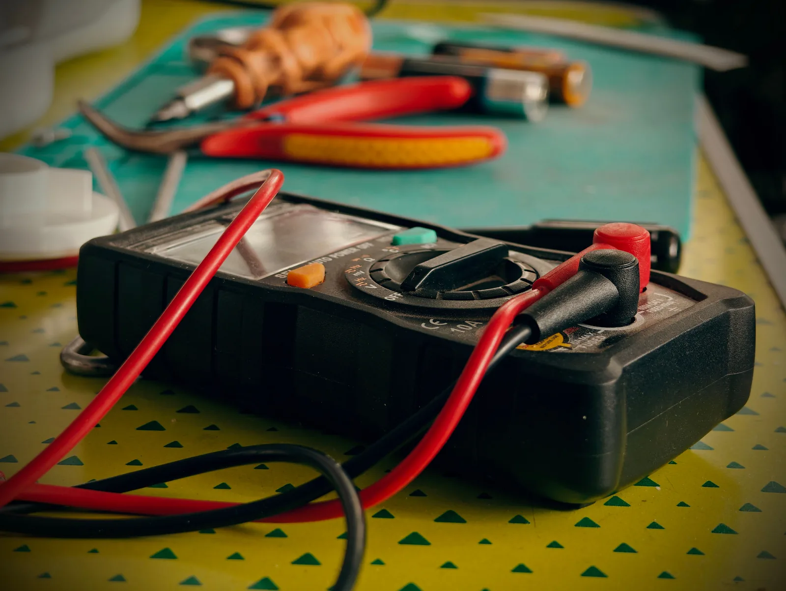 A multimeter and hand tools ready for a diagnostic visit, for electrician in Cincinnati
