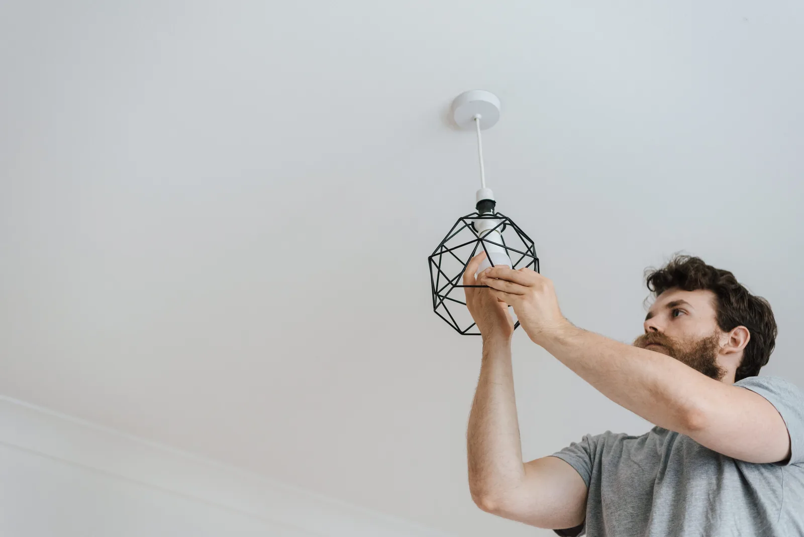 Fitting a lamp into a pendant fixture, for ev charger installation in Cincinnati